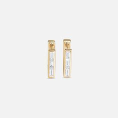 The Ri Noor Skinny Square Diamond Huggie Earrings are a luxe twist on your classic huggie. Featuring three beautiful diamond baguettes set in solid 14k yellow gold. 14k Yellow Gold Diamond Earrings Height is 12mm.