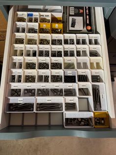 a drawer filled with lots of different types of screws and other things in it