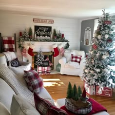 a living room decorated for christmas with red and white decorations