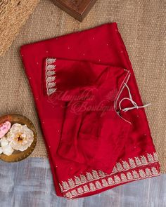 "This Vivid Red Satin Saree Is Ideal For A Celebration Since It Combines Pure Satin, Zardozi, And Pearl Embroidery. A Border With Beautiful Zardozi Embroidery That Catches The Light And Provides A Delicate, Feminine Touch Is Enveloped By The Vibrant Red Smooth Surface, Which Is Touched With The Grandeur Of Pearl Embroidery Throughout The Saree, Giving It A Subtle Shimmer. An Accompanying Self-Plain Blouse Has A Work Neck And Hands. The Blouse Measures 38\" In Length And Extends To 44\"." Red Saree Plain, Red Satin Saree, Saree Plain, Zardozi Embroidery, Pearl Embroidery, Shibori Dye, Set Saree, Delicate Feminine, Satin Saree