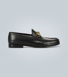 A true classic, these black leather loafers from Gucci feature the label's iconic Horsebit detail over the bridges and are crafted in Italy. Gucci Calf Leather Loafers With Rubber Sole, Leather Horsebit Loafers, Classic Gucci Calf Leather Shoes, Gucci Office Loafers With Rubber Sole, Office Gucci Loafers With Rubber Sole, Gucci Leather Shoes With Calf Leather Sole, Gucci Calf Leather Shoes With Leather Sole, Luxury Leather Loafers With Horsebit Detail, Designer Calf Leather Loafers With Horsebit Detail