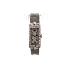 Antique Art Deco Diamond Watch in Platinum & 18k This Art Deco antique manual wind watch is an antique blend of platinum and 18 karat white gold, showcasing the opulence of its era. The watch features a rectangular face adorned with meticulously set diamonds, creating a brilliant display. The primary diamond, an old European cut weighing .12 carats, has SI2 clarity and I color. The accent diamonds, totaling .87 carats, number 46 in all, each measuring 1.65 mm and weighing .019 carats. These diamonds are arranged beautifully, enhancing the watch's milgrain and filigree details, hallmarks of the Art Deco style.  The watch's mesh bracelet, crafted from white gold, complements the platinum watch face perfectly, providing a seamless and elegant look. While the watch is in working condition, due Luxury Rectangular Art Deco Watches, Antique Platinum Evening Watches, Art Deco Platinum Evening Watches, Timeless Engraved Formal Watches, Elegant Engraved Watch With Rectangular Dial, Platinum Art Deco Evening Watches, Timeless Engraved Watches For Formal Occasions, Antique Rectangular Evening Watch, Vintage Diamond Watch With Rectangular Dial