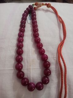 Ruby Necklace Natural Ruby Corundum Smooth Round Beads 513 Carat AAA Ruby Necklace With Adjustable Code Necklace 1.Ruby Corundum 2. Ruby Round Beads 3. 14 inches length, 1 Line String 4. 513 -carat weight 5. 10x10 - 12x12 mm stone size 6, The necklace is with tassel because you can easily adjust your necklace length. 7. If you want any changes in the necklace example if you want with clasp we can do it. Polish :- Handmade Purity :- AAA These natural Ruby gemstones can be used to make different j Pearl Necklace With Large Beads As Gift, Pearl Necklace With Large Beads For Gift, Red Temple Necklace With Round Beads As Gift, Large Beads Pearl Necklace As Gift, Red Temple Necklace With Round Beads For Gift, Red Beaded Temple Necklace Gift, Round Faceted Beads Pearl Necklace For Jewelry Making, Faceted Beads Pearl Necklace For Jewelry Making, Formal Round Beaded Necklace With Large Beads