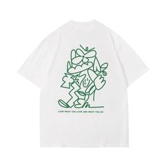 a white t - shirt with green graphics on the front and back, featuring a cartoon character