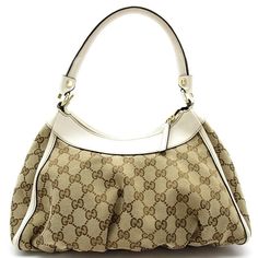 Introducing the Gucci Abby Handbag, a timeless blend of sophistication and style. Crafted with GG canvas and leather in a chic beige hue, this shoulder bag exudes luxury and elegance. The iconic Gucci logo is subtly featured, adding a touch of designer flair to any outfit.Designed for the modern woman on the go, the Gucci Abby Handbag offers both fashion and functionality. The spacious interior provides ample room for all your essentials, while the adjustable shoulder strap ensures comfort and versatility. Whether for a casual day out or a special evening event, this bag is the perfect accessory to elevate your look.Make a statement with the Gucci Abby Handbag - a must-have piece for every fashion-forward individual. Elevate your style game with this exquisite designer bag that effortlessl Chic Monogram Canvas Shoulder Bag For Daily Use, Chic Bags With Handle Drop In Monogram Canvas, Chic Bags With Handle Drop And Monogram Canvas, Chic Shoulder Bag With Double Handle In Monogram Canvas, Chic Monogram Canvas Satchel With Dust Bag, Luxury Cream Hobo Bag With Handle Drop, Timeless Beige Shoulder Bag With Handle Drop, Elegant Bag With Removable Pouch In Monogram Canvas, Elegant Monogram Canvas Bag With Removable Pouch