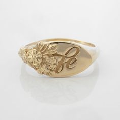 This vintage-inspired floral ring is a row of dainty flowers wrapped around your fingers. Handmade and polished, it is available in solid 8K and 14K gold. This item is engravable with text or monogram of your choice at no extra cost. The initals are engraved onto the ring and embedded in the 3D model for a flawless embossed finish. It is also possible to add a diamond or birthstone or diamond to this ring at an additional fee. Please inquire for details. A few notes about our gold:- Though we do Heirloom Birth Flower Jewelry, Elegant Gold Signet Ring With Birth Flower, Gold Engraved Delicate Rings, Delicate Engraved Gold Rings, Delicate Gold Engraved Rings, Classic Gold Jewelry With Birth Flower, Vintage Initial Ring For Anniversary, Tarnish Resistant, Gold Signet Ring With Birth Flower For Wedding, Gold Wedding Signet Ring With Birth Flower