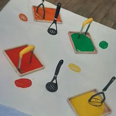 the table is covered with different types of utensils and paint on paper towels