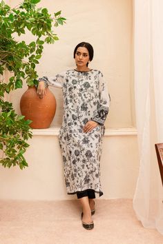 BATIK Zahviya 2Pc - Printed Lawn Dress Ready to wear 2pc dress Flaunt this artfully printed set made from our premium quality Pima lawn in the shades of pearl white. Elegantly printed paneled shirt comes with an embellished neckline - details include lace finishing at neckline and hem. Sleeves are loose fit, adorned with contrasting printed border – finished with lace. Paired with dyed cambric trousers. Disclaimer: Colors may slightly vary due to lighting Premium quality Pima lawn Embellished ne