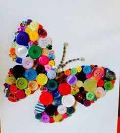 a butterfly made out of buttons sitting on top of a table