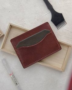 A beautiful classic card wallet, hand stitched with whiskey thread and handmade with Medium Brown Buttero Leather from Conceria Walpier tannery in Italy and accented with a green card slot. This timeless wallet will last a lifetime and age beautifully over time. Handstitched at 4mm spacing using 0.45mm thread . Thread choices : Whiskey (Shown Pic 1-3), Coffee (pictures 5-7) , Cream, Olive, Navy, Grey This wallet can hold 5-6 cards and features a small sleeve to carry cash.  Measures 4.25" x 3" A Gift Bi-fold Card Holder With Waxed Finish, Classic Hand-stitched Wallets As Gifts, Rectangular Waxed Finish Card Holder Gift, Handmade Classic Wallet, Artisan Hand-stitched Wallet As Gift, Handmade Brown Wallet For Daily Use, Cognac Wallet With Interior Card Slots For Gift, Cognac Wallet With Interior Card Slots As Gift, Brown Hand-stitched Card Holder For Gift