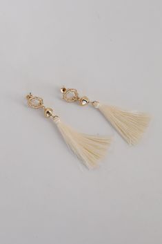 The Gracelyn Gold Tassel Earrings are the hit of the party! These trendy earrings start with a stud post back and have a tassel detail. Add these fun earrings to a black dress + heels to add a chic touch to your date night look! Gold Plated Tassels Stud Post Back One Size | Length 3” Trendy Party Tassel Earrings, Elegant Beaded Tassel Earrings, Elegant White Tassel Earrings, White Tassel Earrings For Party, Chic Formal Summer Earrings, Trendy Tassel Earrings For Party, Elegant Fringe Earrings, Elegant Tassel Earrings For Party, Chic Tassel Earrings For Summer