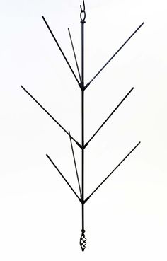 a black and white photo of a metal tree