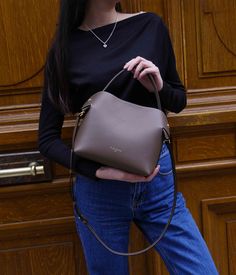 The Medium Swan bag in Dark Taupe, crafted from smooth calf leather, embodies a subtle and versatile elegance, perfectly adapting to a wide range of outfits, from the understated to the boldly colored. Its ideal size provides generous space for your daily essentials while maintaining a chic and streamlined appearance.
The Dark Taupe color, subtle and rich, elegantly harmonizes with a broad spectrum of colors. It naturally pairs with neutral tones such as cream, ivory, or light grey, creating a sophisticated and timeless look. For a striking contrast, combine it with more vivid and bright colors like turquoise, coral, or emerald green.
Precisely crafted in Italy, the Medium Swan bag in Dark Taupe stands out with its refined metallic finishes and elegant design. Its versatility allows it to Elegant Solid Color Box Bag For Office, Elegant Solid Color Office Box Bag, Elegant Solid Box Bag For Office, Luxury Workwear Bag In Solid Color, Calf Leather Bucket Bag For Office, Luxury Workwear Bags, Chic Satchel With Double Handle And Smooth Grain, Elegant Solid Box Bag For Daily Use, Classic Calf Leather Bucket Bag For Office