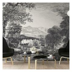 two chairs and a table in front of a wall mural