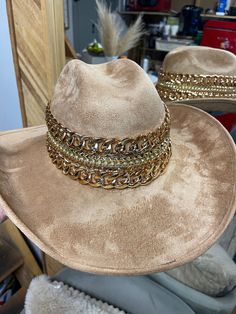 GB ORIGINAL!! The “Beth Dutton” Chain Banded Suede Hat in Taupe – Glitzy Bella Gold Wide Brim Fedora For Festivals, Gold Wide Brim Fedora For Party, Elegant Gold Hat For Festival, Elegant Gold Festival Hat, Western Gold Fedora With Short Brim, Western Style Gold Fedora With Flat Brim, Western Style Gold Fedora With Short Brim, Brown Western Fedora For Party, Western Style Brown Fedora For Party