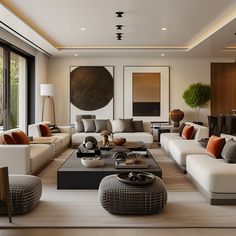 a large living room with white couches and brown accents on the walls, along with windows