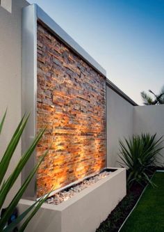 an outdoor water feature with rocks and plants