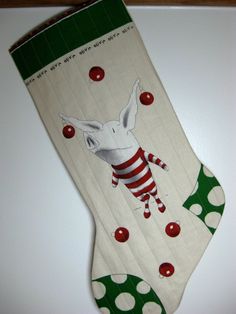 a christmas stocking with an image of a pig hanging from it's side