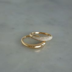 Bold is the way to go. Stacked or separate, these beautiful rings will do the talking for you.The Dome Duo Gift Set includes: The Gold Dome Ring: Keep it simple while making a statement in our 14k gold dome ring. The Diamond Dome Ring: With pavé diamonds and 14k gold, this dome ring takes style to new heights. $2,300 value which means you save 15% and a whole bunch of time since we did the styling for you. There’s something to be said about a solo moment, but we believe style should be stacked. Jewellery Rings Gold, White Gold Band Ring, Round Rings Gold, Dome Wedding Ring, Basic Gold Ring, Dome Gold Ring, Daily Ring Stack, Yellow Gold Domed Dome Ring For Promise, Stackable Dome Ring For Formal Occasions