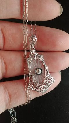 Stunning Art Deco Necklace, Pendant and Original Chain, made from 14k White Gold, approximately 0.15ct Old Mine Cut Diamond, Camphor Glass, Filigree design... Diamond is approximately 0.15ct, VS, GH.. Perfect Antique Condition. All sales are final. Weight is 4.1 Grams. Layaway plan is Available.. Some pics Enlarged to see details. Antique Round Necklace With Diamond Accents, Antique Round White Gold Necklace, Antique White Gold Round Necklace, Art Deco White Gold Oval Necklace, Antique White Gold Necklace With Diamond Accents, White 14k Gold Filigree Jewelry, Antique White Gold Necklace With Intricate Design, Exquisite Engraved White Gold Necklace, White Gold Victorian Necklace For Anniversary