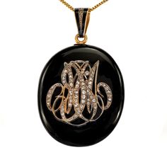 "Queen Victoria set the example for wearing mourning jewelry and it quickly became fashionable. This laboriously cut black onyx showcases antiqued gold initials with seventy-two rose-cut diamonds. On the back, you will see an encapsulated pocket to store photos, or more traditionally, a locket of hair. Perfect for a layering option, we have added an extinct, fossilized Trilobite pendant. Trilobite 1.20 x 0.65\" Trilobite is in gold-plated setting Brooch 2.75 x 1.50\" Brooch Depth 9mm 72 rose-cut