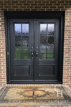 a black double door with glass on the side