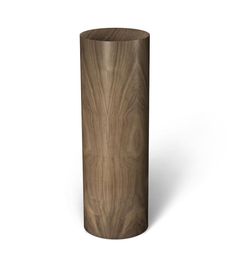 a tall wooden vase sitting on top of a white surface