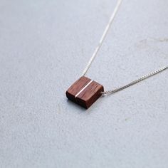 This handcrafted dainty square walnut pendant is made with a silver inlay paired with an adjustable sterling silver threader chain(16-22in) perfect for any style you choose to wear it with. Brown Square Pendant Jewelry For Gift, Adjustable Sterling Silver Necklace With Square Pendant, Adjustable Brown Sterling Silver Necklace, Adjustable Brown Sterling Silver Necklaces, Minimalist Brown Necklace For Gift, Minimalist Brown Necklace For Gifts, Minimalist Brown Sterling Silver Jewelry, Minimalist Brown Necklace For Everyday, Minimalist Brown Jewelry For Gift