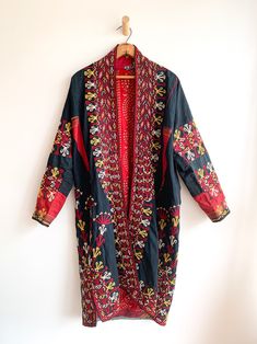 Fantastic traditional Turkmen robe/duster. Vivid colors and carefully embroidered workmanship. One of the best examples of this type of traditional wear we have come across. Infinitely wearable and looks great with jeans and boots. Add flair to a jeans and t uniform. Fabric: cotton/silk/ otherFit: S/MEra: 1940's Measurements: Bust 48" Sleeve (from collar) 32" Length 43" Waist 48" Hips 52" Condition: Excellent Traditional Fitted Cotton Kaftan, Fitted Cotton Traditional Kaftan, Folk Style Embroidered Festival Kimono, Traditional Long Robe For Festival, Traditional Outerwear With Embroidered Border For Fall, Traditional Robe With Kimono Sleeves For Festivals, Traditional Kimono Sleeve Festival Robe, Traditional Fitted Outerwear With Embroidered Border, Traditional Fitted Kimono With Kimono Sleeves