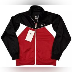 Get Your Little Athlete Ready For Any Sports Activity With This Nike Track Jacket. Made Of 100% Polyester, This Jacket Is Perfect For Activewear And Comes In A Stylish Black, White, And Red Color Combination. The Jacket Is Designed For Boys And Is Available In Size 7. This Track Jacket Is Ideal For Sports Enthusiasts And Is Perfect For Any Outdoor Activity. The Jacket Features A Brand Logo And Is Made With High-Quality Material To Ensure Durability. Get Your Child Ready For Any Sports Adventure Nike Outerwear For Sports Events In Fall, Nike Fall Outerwear For Sports Events, Red Athleisure Tracksuit For Fall, Nike Tracksuit For Gym In Winter, Sporty Tracksuit For Outdoor Fall Activities, Black Outerwear For Training In Fall, Black Outerwear For Fall Training, Nike Sporty Windbreaker, Nike Sporty Outerwear For Sports Events