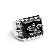 Description: Introducing the Military Eagle With Cubic Zirconia Accents Stainless Steel Ring! This bold and sophisticated piece features a silver eagle design component atop a black enamel inlay with two sparkling cubic zirconia accents on both sides. It's the perfect piece for accentuating your power and authority in a stylish way and symbolizes the strength and courage of the United States Military. Whether you are currently serving or have served in the U.S. military, this brilliant ring is a Formal Silver Ring With Black Enamel, Silver Rings With Black Enamel And Diamond, Silver Diamond Rings With Black Enamel, Black Cubic Zirconia Jewelry With Polished Finish, Formal Silver Enamel Rings, Eagle Design, Silver Eagles, Jewelry Website, Stylish Rings