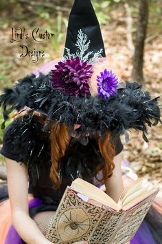 a woman wearing a witches hat reading a book