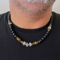 "Men's Necklace with citrine, Beaded boho necklace for men Beautiful and unique necklace I created by using black stones with Citrine, Tiger's eye, and Pyrite. This impressive and powerful necklace is charged with the energies of gems The color combination and shapes of the stones give a natural, earthy feel. Beautiful necklace for everyday use. Perfect to keep or to give as a gift. This Necklace comes gift-wrapped, ready to be gifted. Materials: *Black Stone *Citrine *Pyrite *Tiger eye *Stainle Crystal Necklace For Men, Xmas Gift Idea, Beaded Boho Necklace, Pyrite Necklace, Man Jewelry, Men's Necklaces, Wooden Bead Necklaces, Diy Jewelry Necklace, Men's Bracelets