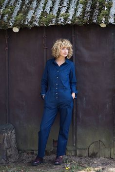 "Work-wear style coverall made in indigo blue medium weight denim. Relaxed fit. Pointed shirt collar, button closure, interior waist with belt loops. Long sleeves with cuff and button. - Handmade in our studio from 98% cotton 2% spandex - Loose and relaxed fit with buttons opening at the front side - Long sleeves - Two patch pockets on the bust and two long patch pockets on the side. FABRIC&CARE Denim fabric of the coverall is smooth and thick. Hand wash or gently machine washable, hang dry Relaxed Fit Denim Jumpsuit With Buttons For Work, Relaxed Fit Denim Jumpsuit For Work With Buttons, Long Sleeve Denim Blue Utility Jumpsuit, Relaxed Fit Dark Wash Denim Jumpsuit With Buttons, Relaxed Fit Denim Blue Jumpsuit With Buttons, Dark Wash Denim Jumpsuit With Buttons And Relaxed Fit, Dark Wash Long Sleeve Denim Jumpsuit With Button Closure, Long Sleeve Denim Jumpsuit With Buttons For Work, Blue Relaxed Fit Denim Jumpsuit In Utility Style