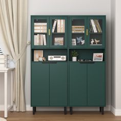 a green cabinet with books on it in a room