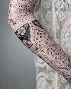 a woman's arm with tattoos on it