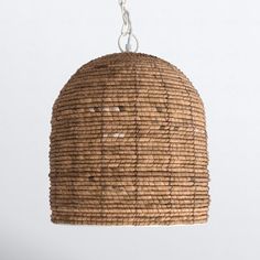 a hanging light made out of woven material and metal chain, on a white background