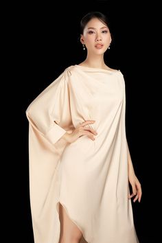 The luxurious silk blend drapes effortlessly and the asymmetrical boat neck adds a touch of sophistication. Perfect for any formal occasion, this dress exudes grace and style.  Length: From 135cm to 140cm Mean Blvd, Floor Length Dress, Floor Length Dresses, Satin Dress, Batwing Sleeve, Designer Collection, Satin Dresses, Boat Neck, Formal Occasion