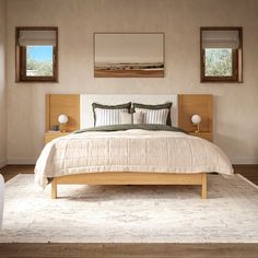 a large bed sitting in a bedroom next to two framed pictures on the wall above it