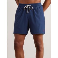 Polo Ralph Lauren's 'Traveler' swim shorts are cut in a comfortable mid-length shape, so you can be active in them on the beach. They're made from moisture-wicking stretch-shell and lined in lightweight mesh. Sporty Navy Swimwear With Built-in Shorts, Casual Sports Swimwear With Short Legs, Navy Swimwear With Built-in Shorts, Blue Nylon Athletic Shorts For Beach, Blue Swim Trunks For Summer With Short Inseam, Blue Swimwear With Short Inseam For Summer, Short Beachwear Swim Trunks For Sports, Casual Solid Color Swimwear With Short Leg, Casual Solid Short Leg Swimwear