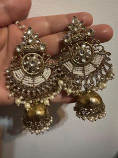 This stunning ,beautiful and stylish bali jhumka earrings are made to take you on a journey of elegance and grace! This one is made for a charmer like you with all the love from Noorzaracollection! Truly traditional and cultural experience, Bali Jhumka earrings enriched in kundan stones and pearl work! This design offer a classic sparkle and contemporary finish in one! Glamorous bali earrings embedded with Polki stones big size jhumka earrings in gold polish! In stock and ready to ship. color : antique gold Note :Color, shades, texture displayed may slightly vary from the actual product due to digital image limitations. We request you to consider these minor variations. Please expect the possibility of some slight imperfections when buying handmade jewelry. If you have any questions, pleas Bohemian Earrings With Mirror Work For Party, Earrings Bali, Hyderabadi Jewelry, Indian Jhumka, Earrings Jhumka, Jewelry Pakistani, Pearl Work, Bali Earrings, Kundan Jewelry