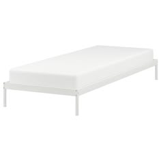 a white bed frame with no sheets on it