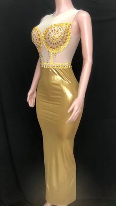 Introducing our stunning handmade Golden Graduation Gown, a masterpiece of elegance and glamour. Crafted with meticulous attention to detail, this gown is designed to make you shine on your special day. Made from a luxurious blend of spandex and polyester, this gown offers a perfect balance of comfort and style. The fabric drapes beautifully, enhancing your silhouette and allowing you to move with grace. Breathable and sustainable, this gown ensures you stay comfortable throughout your graduation ceremony. The fabric allows for airflow, keeping you cool and confident as you receive your well-deserved accolades. The empire waistline adds a touch of regal charm, creating a flattering and elongating effect. It accentuates your figure and adds an element of sophistication to your overall look. Gold Dress With Sheer Bodice For Prom, Gold Sheer Bodice Dress For Prom, Party Gown With Fitted Bodice And Long Train, Elegant Gown For Prom Season And Glamorous Events, Gold Sleeveless Ball Gown For Party, Elegant Gown For Glamorous Events During Prom Season, Gold Mermaid Dress For Wedding And Prom Season, Gold Ball Gown Dress With Sweep Train, Gold Ball Gown With Sweep Train