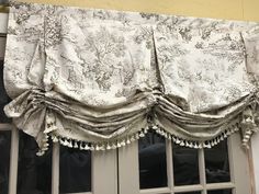 the curtains are hanging on the window sill