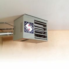 an air conditioner mounted to the ceiling in a room