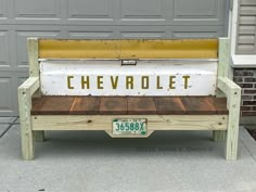 a bench made out of wood with the word chevrolet painted on it's back