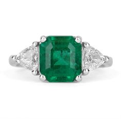 "Shower her with love with this Colombian emerald and diamond cocktail ring. An extraordinary custom-created ring. Designed and created by our own master jeweler, \"Robinson\". Dexterously handcrafted in gleaming platinum. 2.30-carat natural Colombian emerald - emerald cut from the famous Muzo mines. Set in a secure prong setting for extra protection, this extraordinary emerald has stunning green color, strong saturation, tone, and an incandescent glow. Delicately cut with proper dimensions, the Gia Certified Trillion Cut Emerald Wedding Ring, Luxury Trillion Cut Diamond Emerald Ring, Luxury Trillion Cut Emerald Diamond Ring, Luxury Trillion-cut Emerald Ring, Luxury Gia Certified Trillion Cut Emerald Ring, Luxury Gia-certified Trillion Cut Emerald Ring, Luxury Trillion Cut Emerald Jewelry, Luxury Green Trillion Cut Jewelry, Luxury Three-stone Emerald Ring For Anniversary