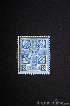 a blue and white stamp with a cross on it's side, in front of a black background