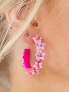 These earrings add a playful, summer inspired touch to any look. The thread wrapped hoop features floral details throughout the silhouette to add a bold touch to your summer look. Spring Flower Jewelry With 3d Flowers, Pink Earrings With Handmade Flowers For Spring, Pink Handmade Flower Earrings For Spring, Spring Pink Earrings With Handmade Flowers, Summer Pink Jewelry With 3d Flowers, Spring Jewelry With 3d Flowers, Pink Flower Earrings For Summer, Summer Beach Jewelry With Flower Shape, Trendy Flower-shaped Summer Jewelry