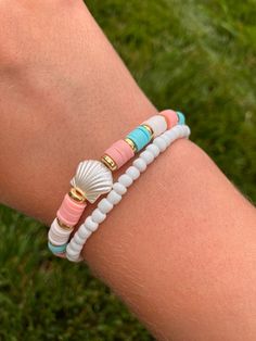 Trendy preppy bracelet 🐚 *Handmade Bracelet set - comes with 2 bracelets (one white seed bead and one blue, coral, white clay bead with shell) *Bracelet length is 6 1/2 inches long with stretchy string *Tie closure Great for stacking or wear alone.  Create your own unique stack with other bracelets from my shop! Willow approved 🐰! Clay Bead Bracelets With Turtles, Clay Bead Bracelets With Shell, Clay Bead Bracelet Ideas Seashell, Beach Bracelets Aesthetic Clay Beads, Seed Bead And Clay Bead Bracelets, Beach Clay Bracelet Ideas, Preppy Bracelet Stack Ideas, Beaded Jewelry Preppy, Clay Need Bracelets